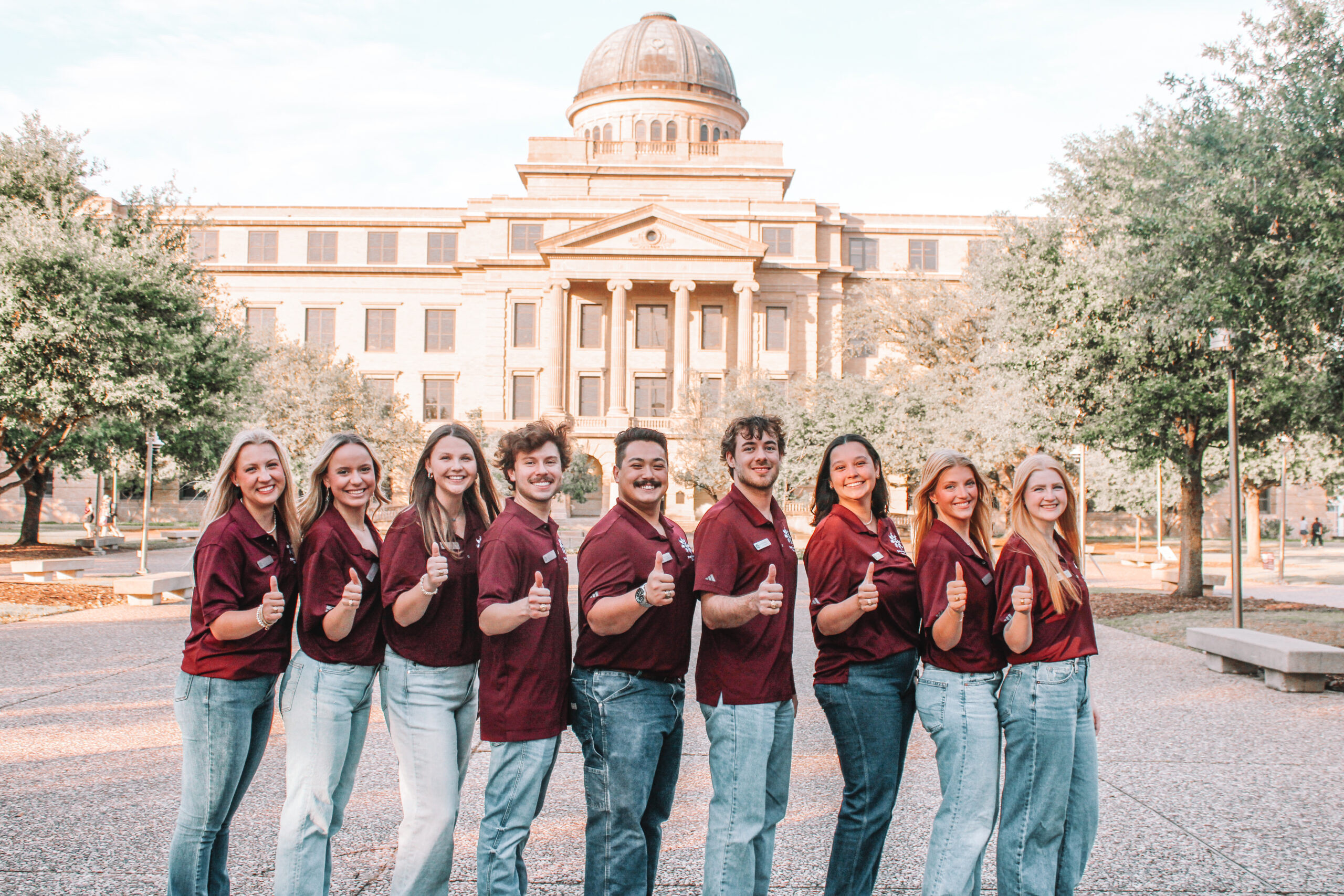 Fish Camp directors hold up a Gig 'Em